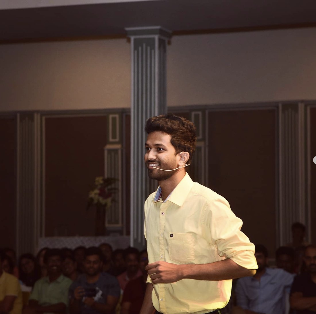 Savan on stage at HPE Storage celebration 2020, yellow shirt and headset mic